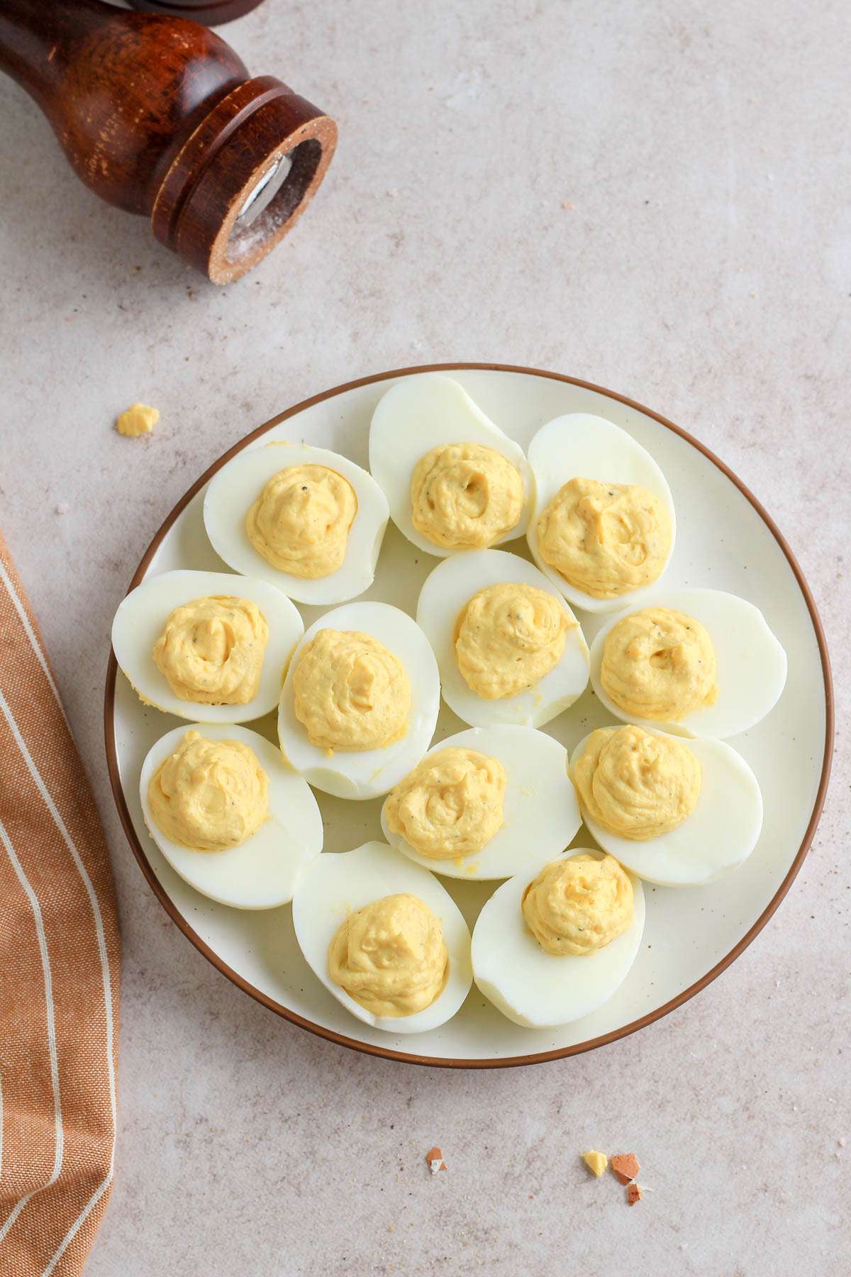 A white plate with a brown rim topped with classic deviled eggs.