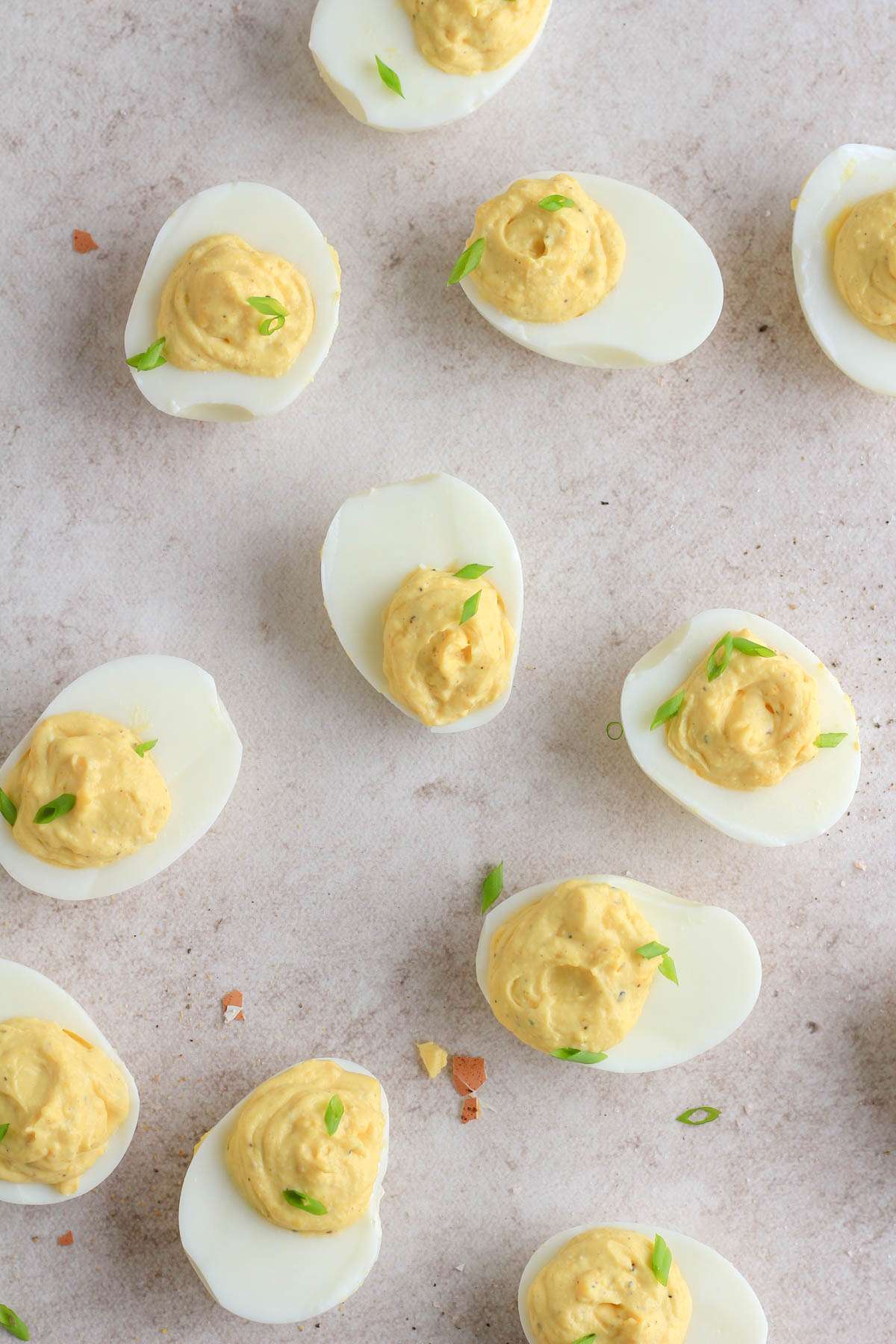 A tan counter with classic deviled eggs spaced out on the counter.