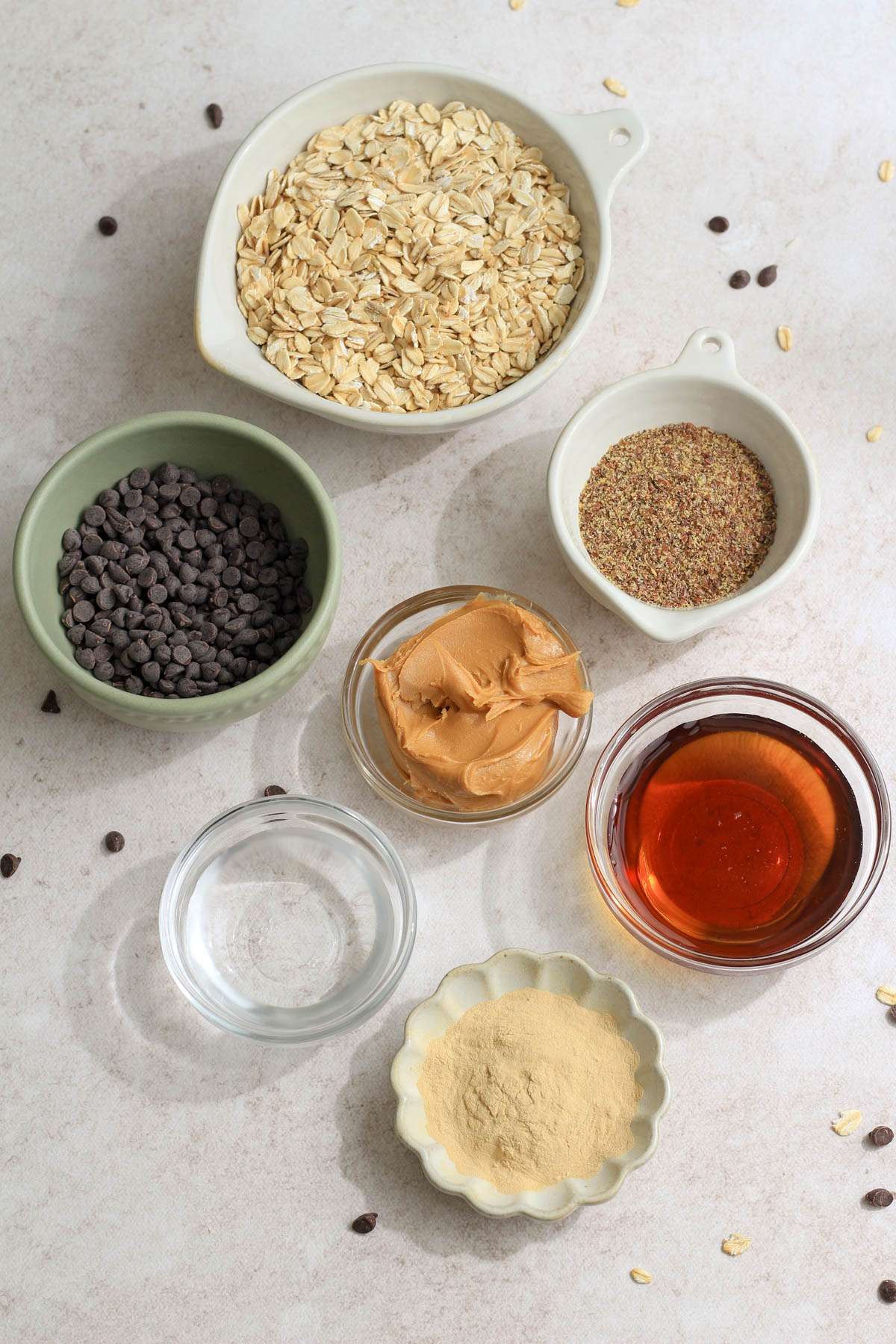Ingredients for peanut butter chocolate chip lactation bites on a tan counter.