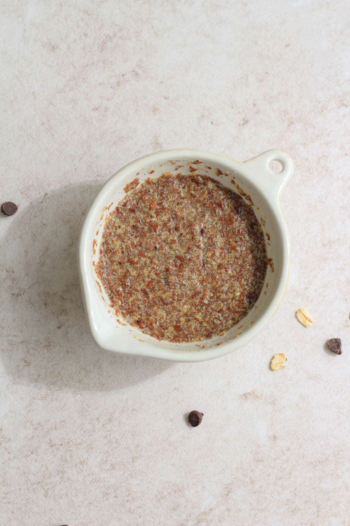 A small mixing bowl with ground flax and water mixed together.