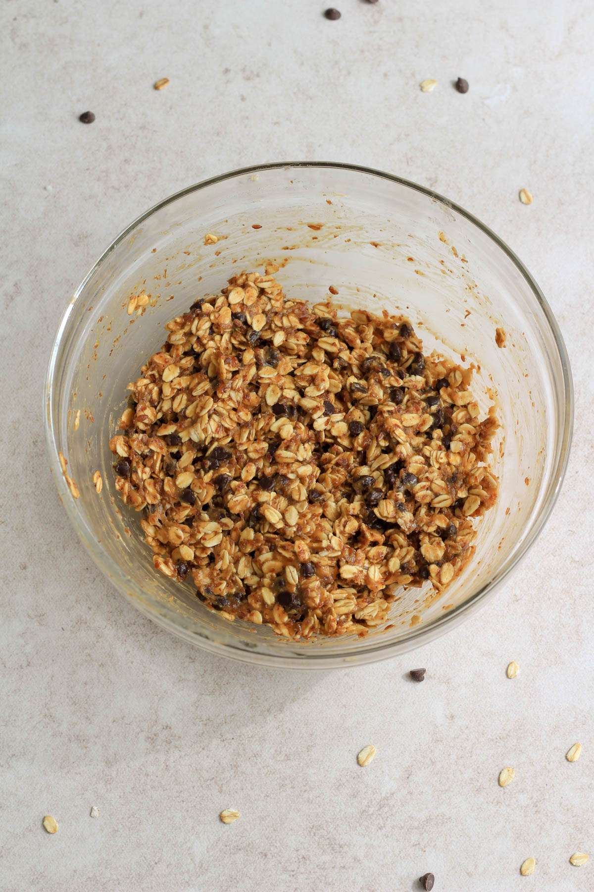 Chocolate chip peanut butter lactation bite mixture after chilling in a glass mixing bowl.