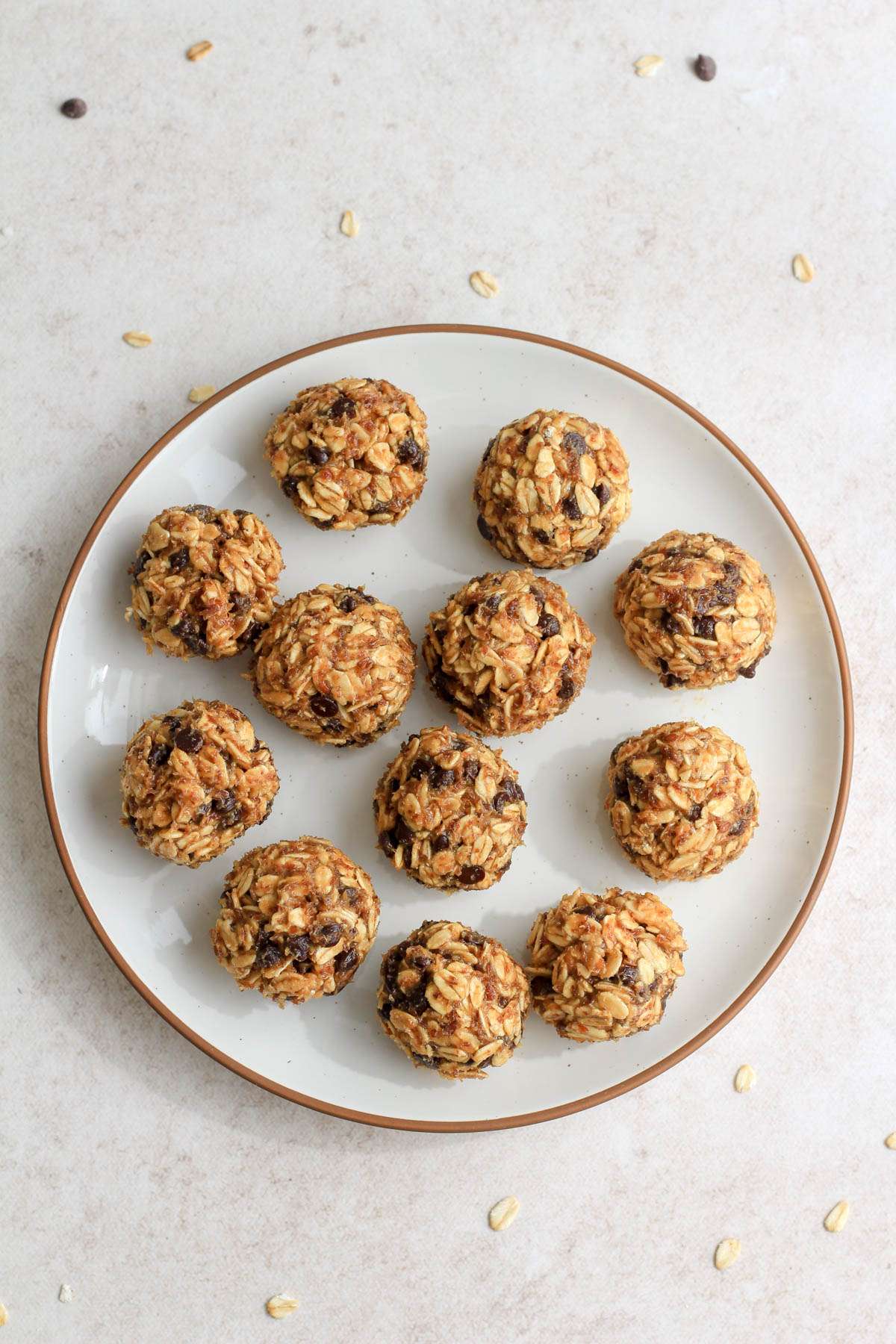 A white plate with a brown rim with rolled lactation bites.
