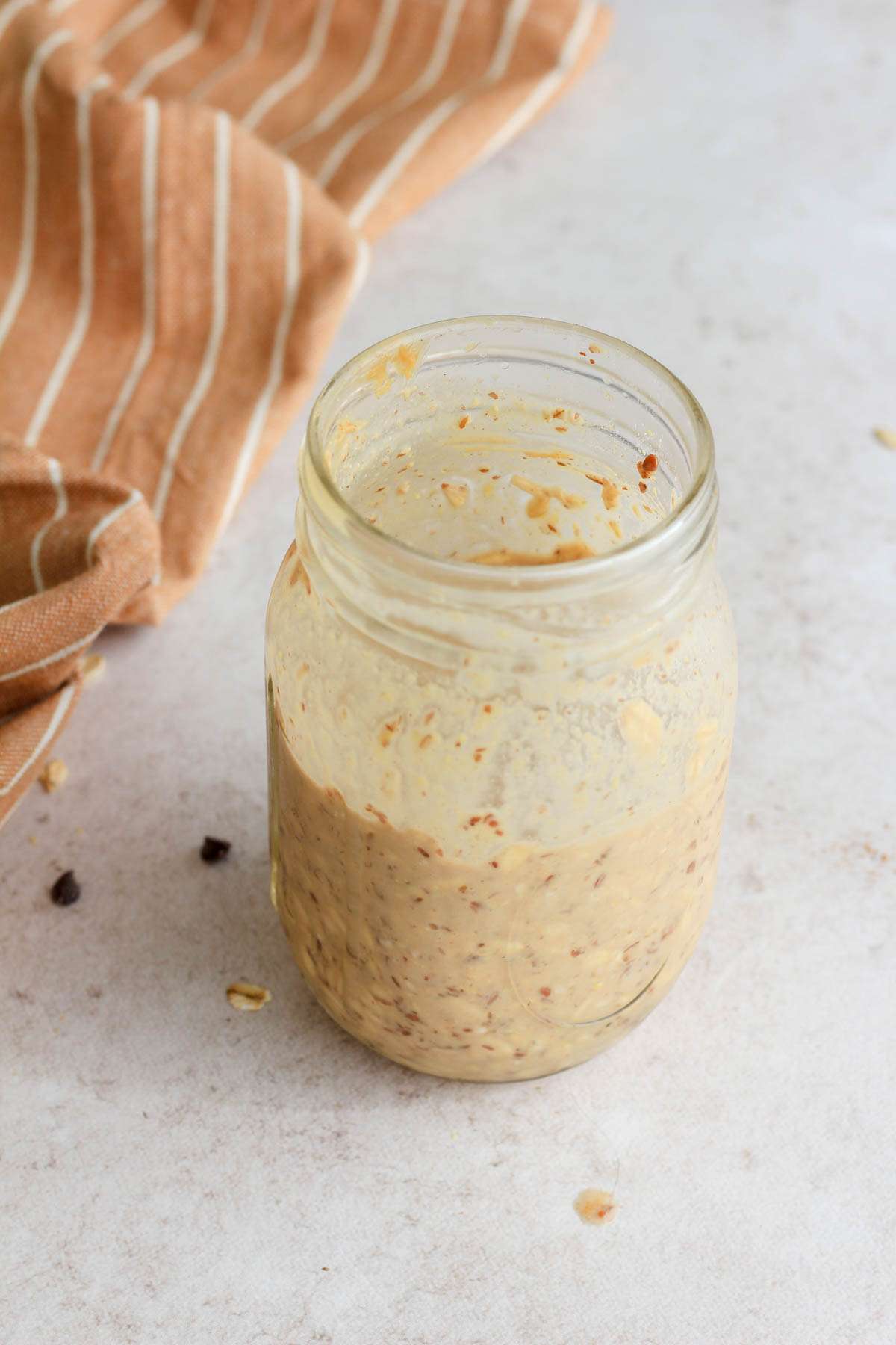 A jar of peanut butter lactation overnight oats after being in the fridge overnight.