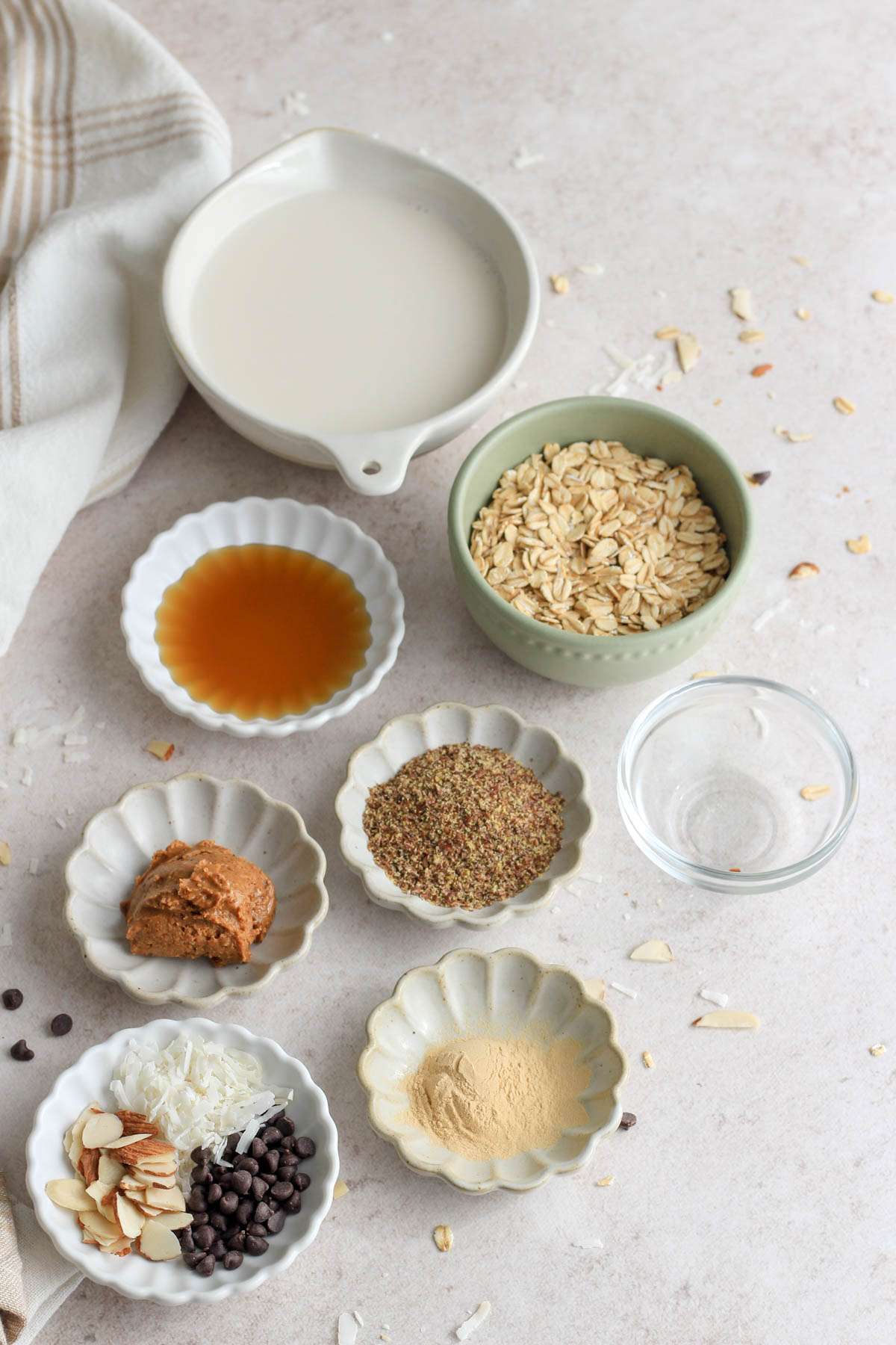 Ingredients for almond joy lactation overnight oats on a tan counter.