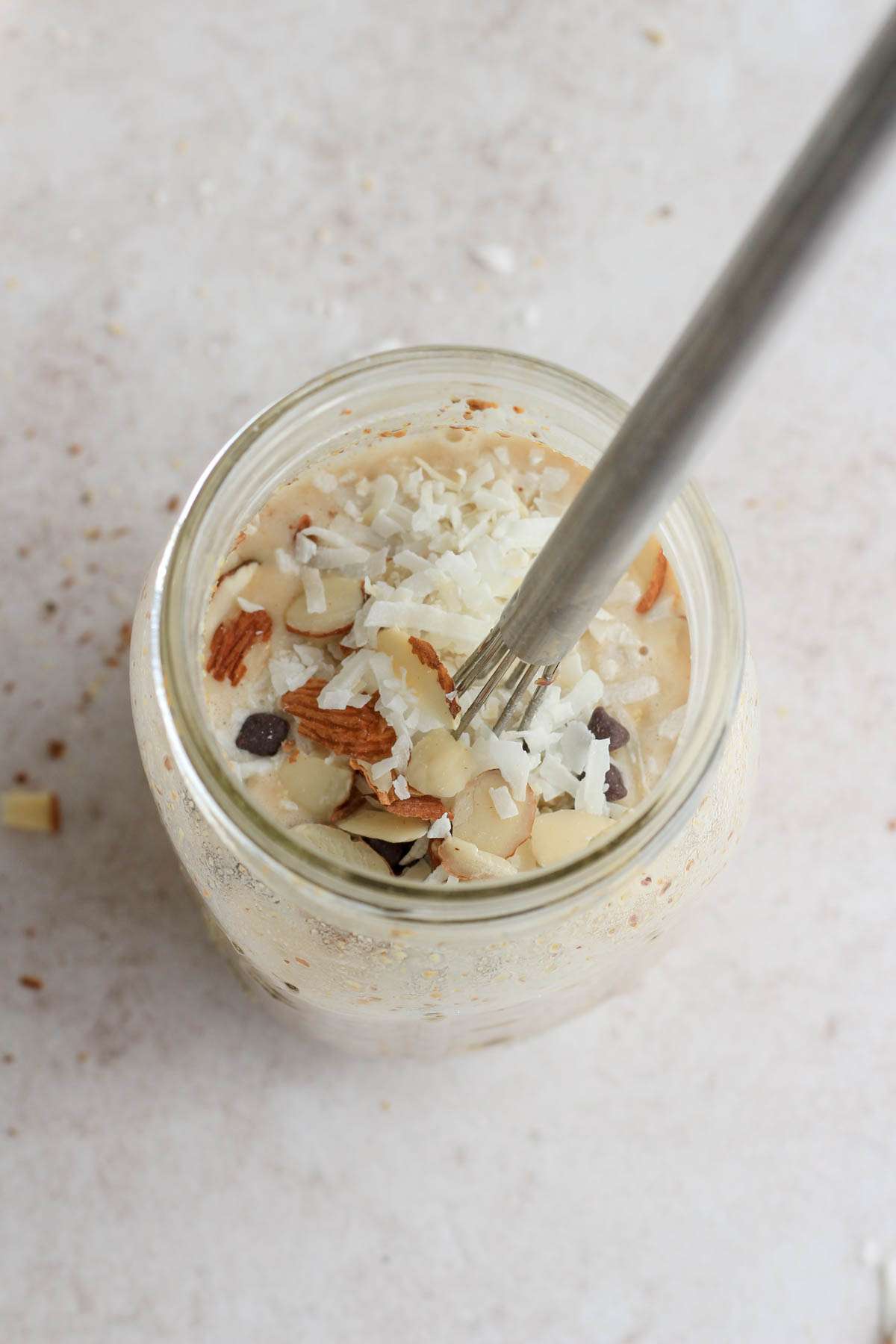 A top down image of almond joy lactation overnight oats in a mason jar before chilling.