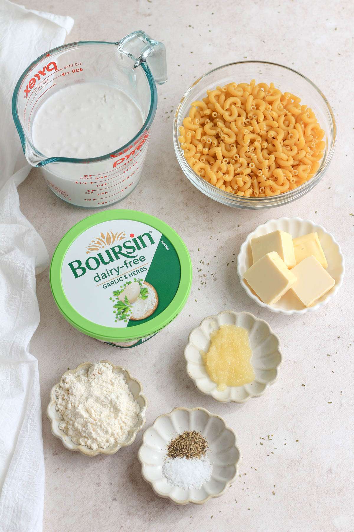 Ingredients for vegan Boursin pasta on a cream counter.