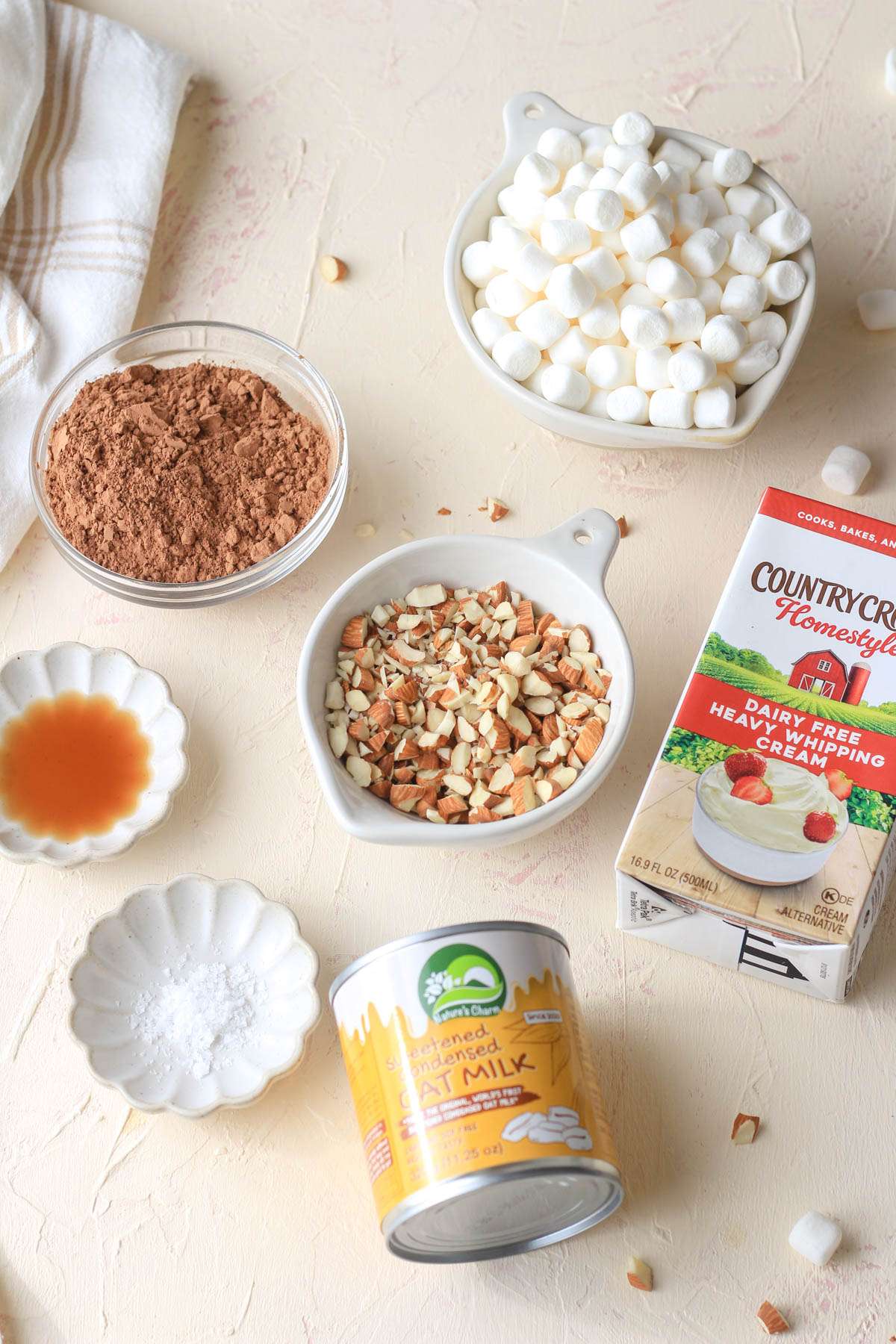 Ingredients for dairy free rocky road ice cream on a cream counter.